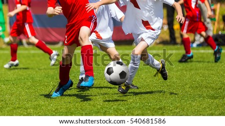 Football Soccer Kick. Soccer Players Duel. Children Playing Football Game on Sports Field. Boys Play Soccer Match on Green Grass. Youth Football Tournament Teams Competition