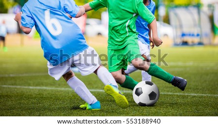Soccer Football Match. Kids Playing Soccer. Young Boys Kicking Football Ball on the Sports Field. Kids Playing Soccer Tournament Game on the Pitch. Youth European Football Match