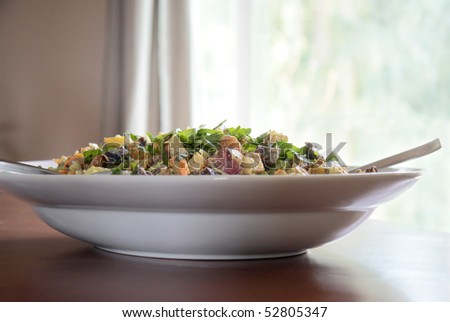 Roasted yellow,blue,and red potato salad with fresh green basil leaves