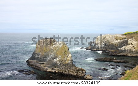 Rugged rock formations jut out of water along Pacific Coast