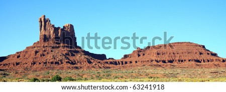 Huge sandstone rock formations tower above floor of Monument Valley on Navajo Indian reservation
