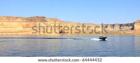 Scenic Lake Powell in Glen Canyon has an abundance of water sport opportunities. The blue lake is populated with house boats, jet skis, and fishermen. It\'s dotted with red sandstone cliff formations.