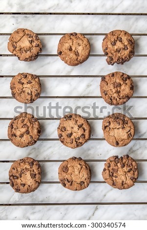 Homemade chocolate cookies over oven rack and white marble background