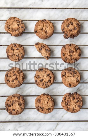 Homemade chocolate cookies over oven rack and white marble background. Top view