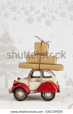 Christmas holiday concept card with gift boxes on toy car
