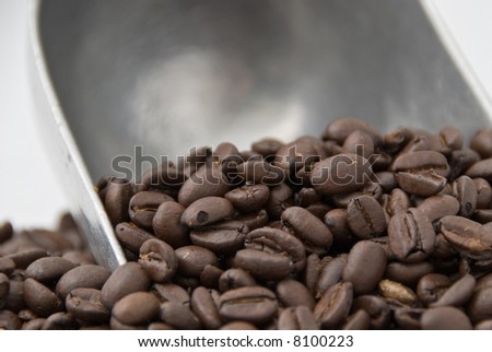 An old-fashioned scoop full of coffee beans. focus on foreground.