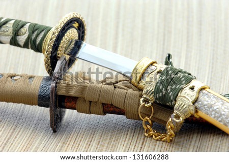 Japanese samurai swords and sheath on wooden board
