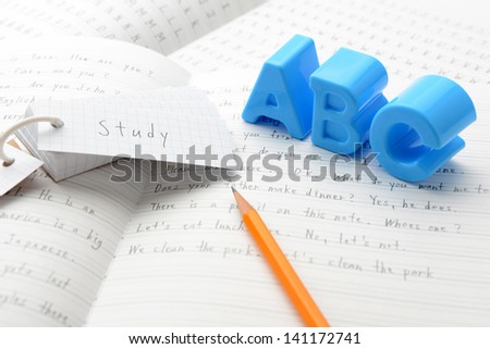 English education, alphabet toy on notebook