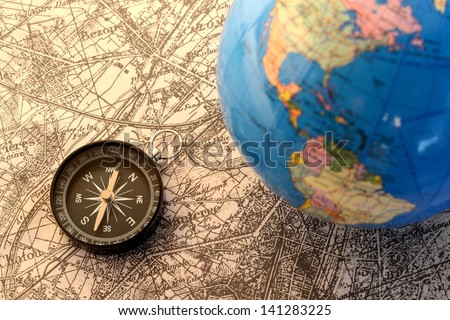 Compass and terrestrial globe on old map
