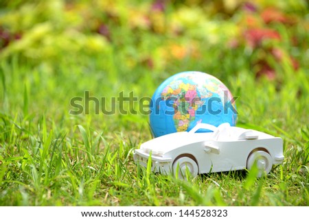 White toy car with terrestrial earth, environmental protection concept