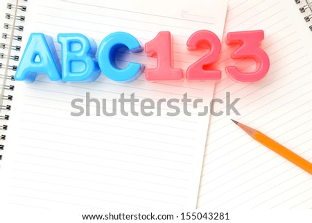 School education concept, alphabet and number toys on notebook