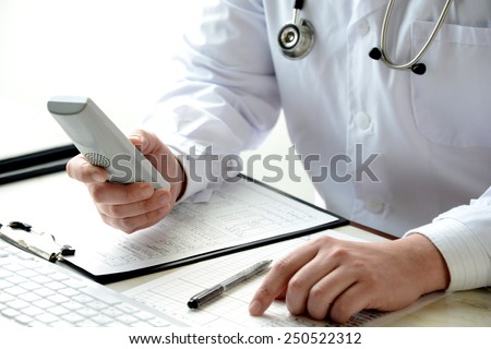 Doctor using telephone in laboratry