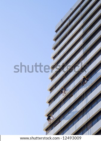 abseiling window cleaners series -  3 window cleaners dangling