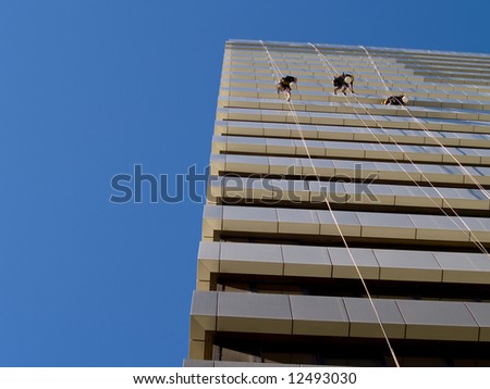 abseiling window cleaners series - directly beneath 3 men with perspective of building