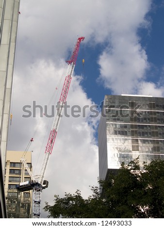 Single Construction Site Crane with textured sky in city setting