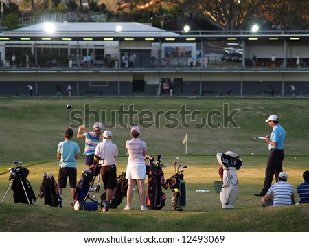 Green Golf Course Series - Kids having a hit on the driving range under the supervision of their teacher