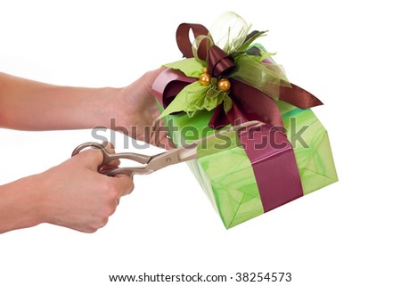 Cutting ribbon with scissors and opening the gift box