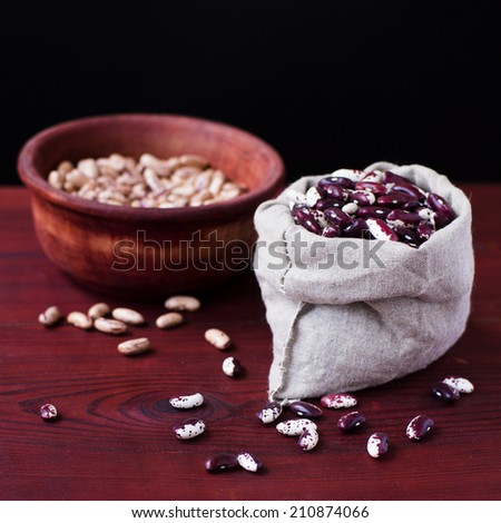 Beans in a cloth bags and in wooden bowl