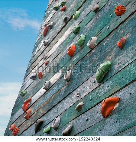 Grunge surface of an artificial rock climbing wall with toe and hand hold studs.