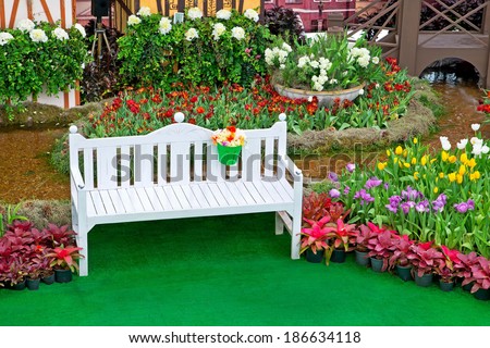 Garden with tulips, white chairs to sit vacation.