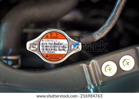 Radiator cap with warning label in a car
