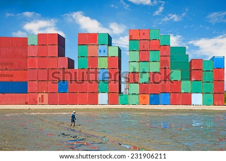 Many containers are stacked together have the farmer\'s rice fields and foreground.