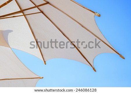 White umbrellas with wooden splines beautifully.