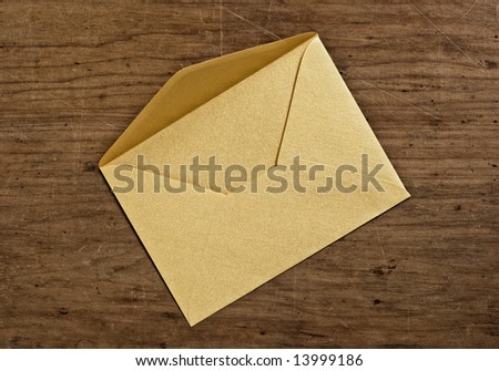Open golden envelope, close up, studio shot.