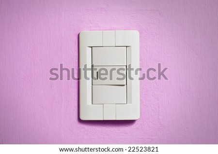 White light switch on old pink wall.
