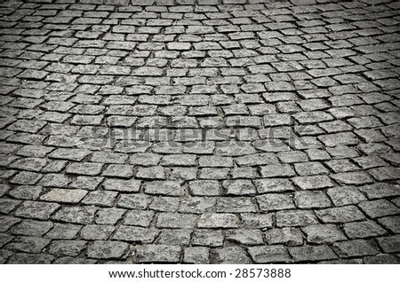 old cobblestone street in perspective and low light.