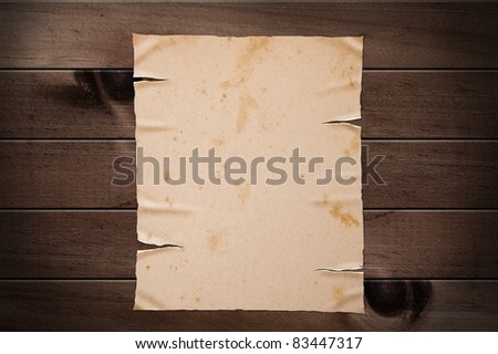 Old yellow paper on wooden wall, clipping path.