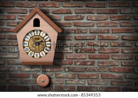 Cuckoo clock on brick wall with copy space.