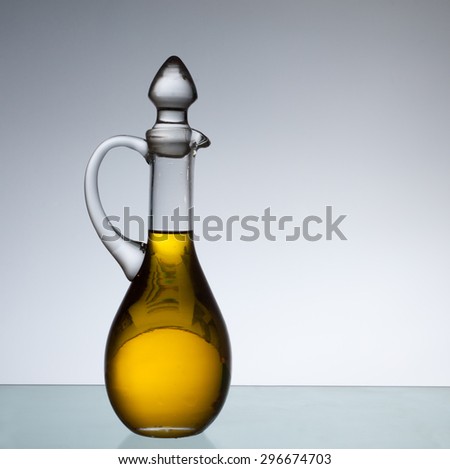 Olive oil bottle in back light. Copy space.