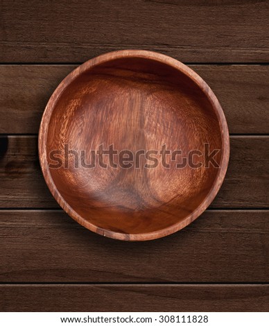 Top view of wooden bowl on  wooden background