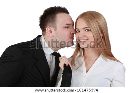Image of a young couple fun while the woman pulls her boyfriend tie for a kiss.