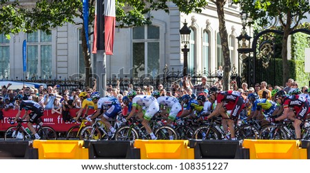 PARIS, JUL 22:The peloton riding during the final stage of Le Tour de France 2012 on Avenue des Champs Elysees on 22 July 2012 in Paris,France.The British Bradley Wiggins wears the Yellow Jersey.