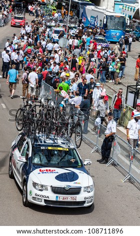 ROUEN, FRANCE,JUL 5 :Lotto-Belisol Team\'s car passing by a crowd of fans to reach the road of the race in Rouen, just before the start of the stage 5th of Le Tour de France on July 5 2012.