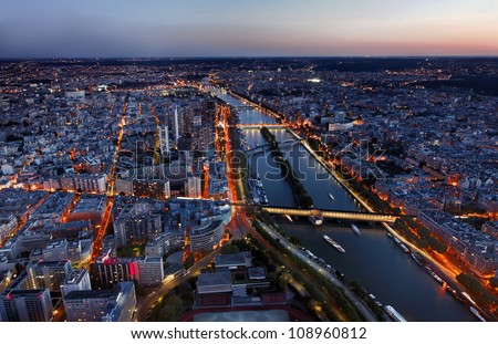 Aerial image of the Seine river and beautiful illuminated quarters in Paris.