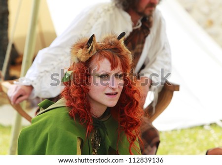NOGENT LE ROTROU,FRANCE,MAY16:  fox woman in front of a traditional tent during  a historical reenactment festival near the Saint Jean Castle on May 16,2010 in Nogent le Rotrou,France