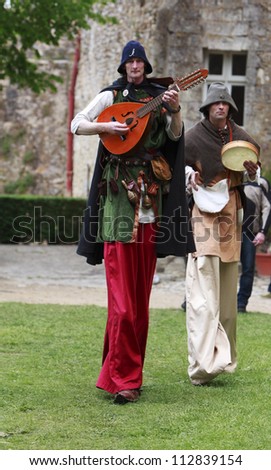 NOGENT LE ROTROU,FRANCE,MAY15 : Medieval troubadours on stilts walking and singing  during a historical reenactment festival near the Saint Jean Castle on May 15,2010 in Nogent le Rotrou,France