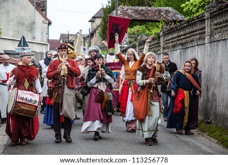 NOGENT LE ROTROU,FRANCE,MAY 19: Parade of medieval characters with old style band marching near the Saint Jean Castle during a historical reenactment festival on May 19,2012 in Nogent le Rotrou,France