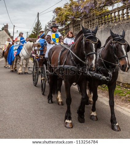 NOGENT LE ROTROU,FRANCE,MAY 19: Parade of medieval characters with a calash and horses near the Saint Jean Castle during a historical reenactment festival on May 19,2012 in Nogent le Rotrou,France