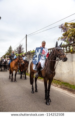NOGENT LE ROTROU,FRANCE,MAY 19:Parade of medieval characters with beautiful horses near the Saint Jean Castle during a historical reenactment festival on May 19,2012 in Nogent le Rotrou,France.