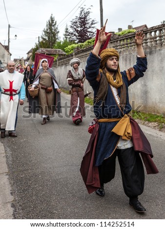 NOGENT LE ROTROU,FRANCE,MAY 19:Parade of medieval characters marching  near the Saint Jean Castle during a historical reenactment festival on May 19,2012 in Nogent le Rotrou,France.
