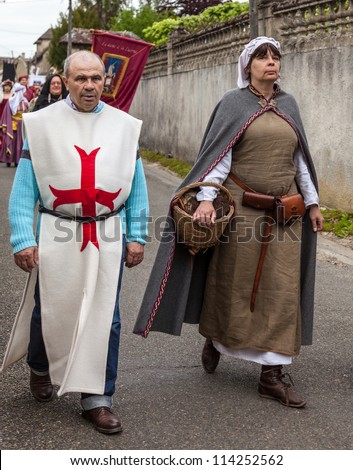 NOGENT LE ROTROU,FRANCE,MAY 19:A couple of medieval characters marching during a parade near the Saint Jean Castle during a historical reenactment festival on May 19,2012 in Nogent le Rotrou,France.