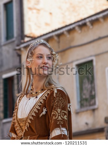 VENICE,ITALY-FEB. 26: Unidentified young woman wears medieval clothes participates in a costumes parade on February 26, 2011 in Venice, Italy. In 2011 the Carnival was held between 11- 21 February.