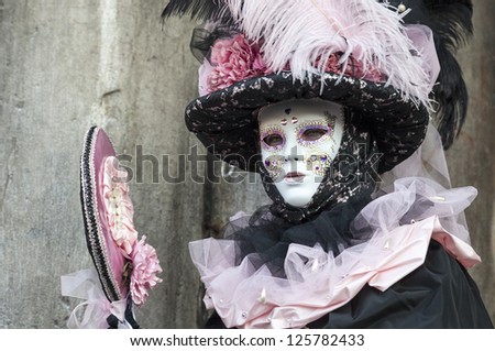 VENICE-FEB 18:Portrait of an unidentified person in a traditional mask with a mirror on February 18, 2012 in Venice. In 2012 the Venice Carnival was held between 11- 21 February.