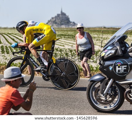 LE PONT LANDAIS,FRANCE-JUL 10: Yellow Jersey (Chris Froome, Great Britain) cycling in front of the Mont Saint Michel monastery, during the stage 11 of Le Tour de France on July 10, 2013