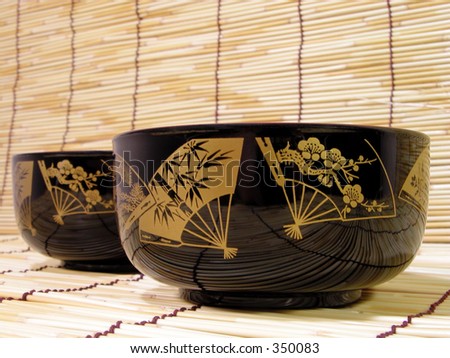 Elegant and traditional bowls on the bamboo straws floor.Only crafts and usual object(similar with a normal plate).