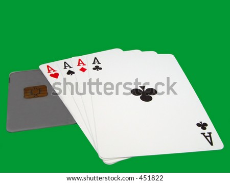 Playing cards and credit card over a green background